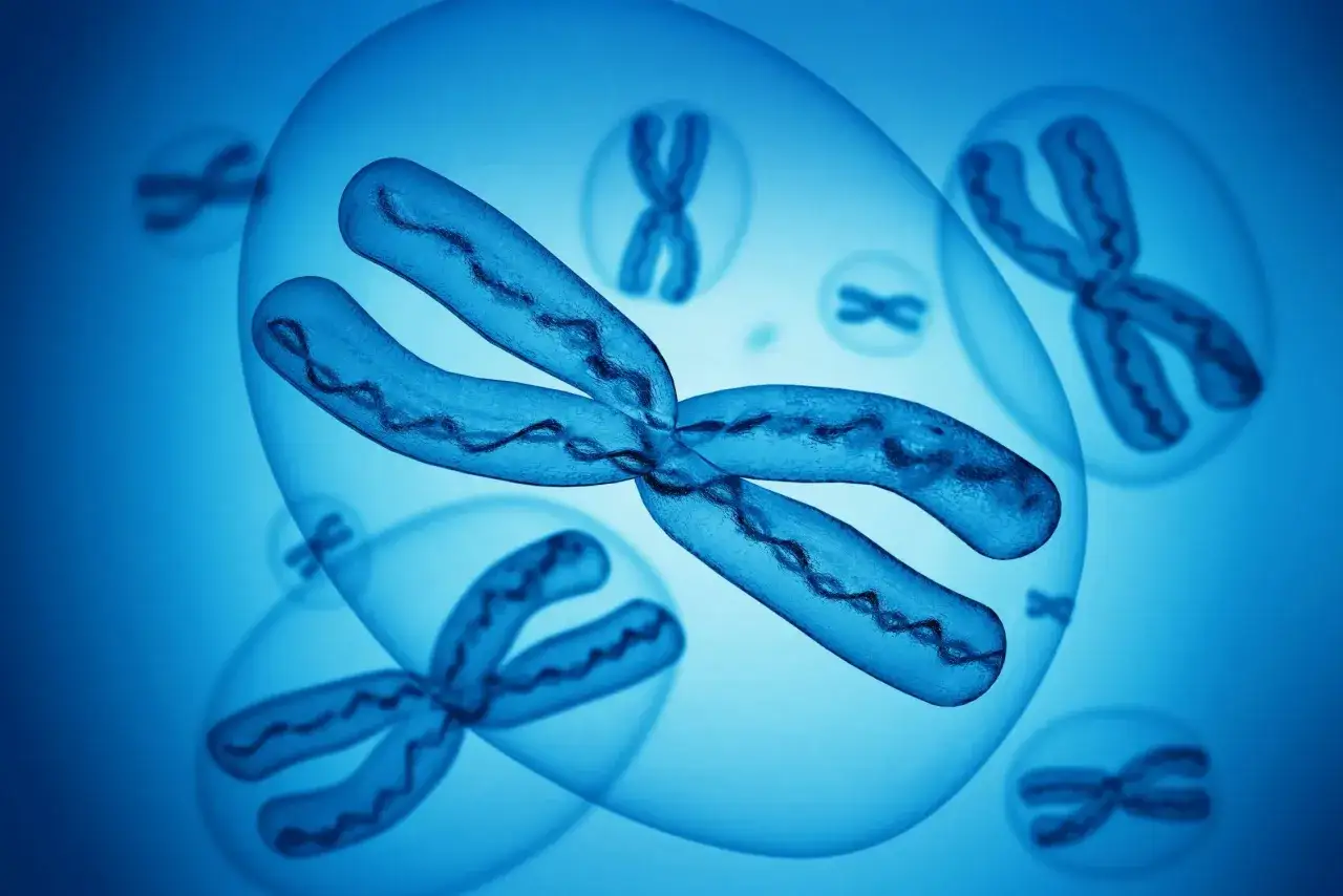 Chromosomy w niebieskich bańkach, symbolizujące genetyczne podłoże zespołu Turnera.